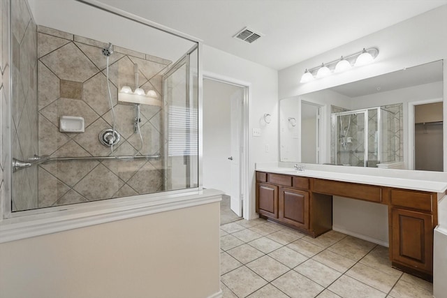 209 Lariat Dr, Fate, TX 75087 - bathroom featuring a stall shower, tile patterned floors, vanity, and a spacious closet