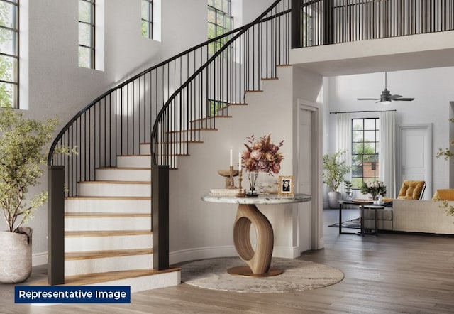 8232 Caprock Trl, Rowlett, TX 75089 - stairway with a high ceiling, wood finished floors, healthy amount of natural light, baseboards, and ceiling fan