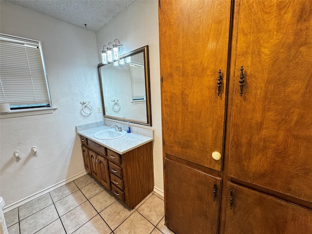 1050 35th St NE, Paris, TX 75462 - bathroom featuring vanity, tile patterned floors, a textured ceiling, and baseboards