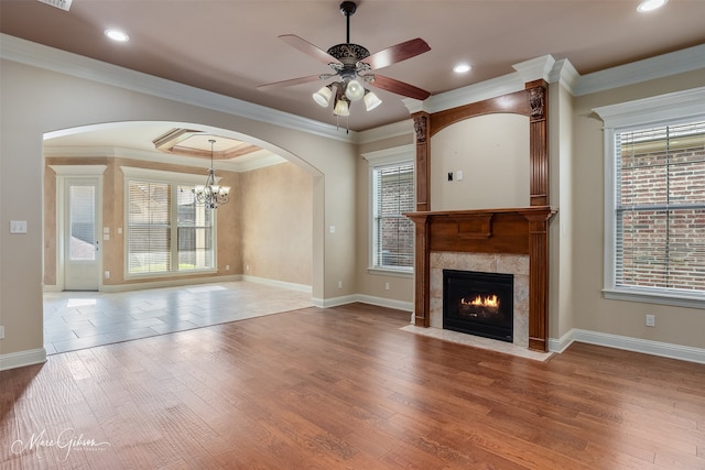 302 Cranbrook Ct, Bossier City, LA 71111 - unfurnished living room with arched walkways, a fireplace, a ceiling fan, wood finished floors, and baseboards