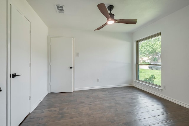 1112 Seabrook Dr, Plano, TX 75023 - spare room featuring dark wood-type flooring, baseboards, and a ceiling fan