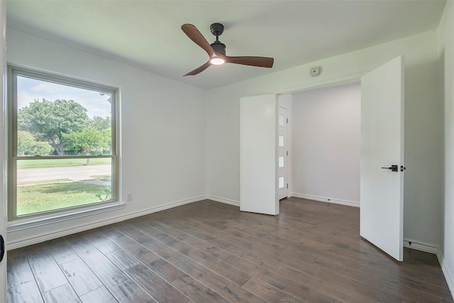 1112 Seabrook Dr, Plano, TX 75023 - empty room featuring dark wood finished floors, baseboards, and a ceiling fan