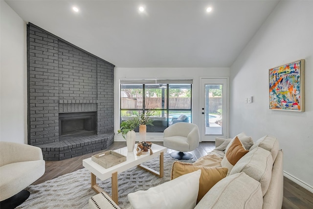 1112 Seabrook Dr, Plano, TX 75023 - living area with lofted ceiling, wood finished floors, a brick fireplace, recessed lighting, and baseboards