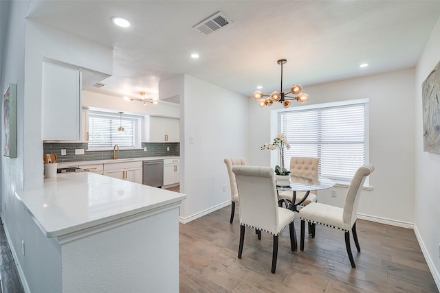 1112 Seabrook Dr, Plano, TX 75023 - dining area featuring a chandelier, wood finished floors, baseboards, and recessed lighting