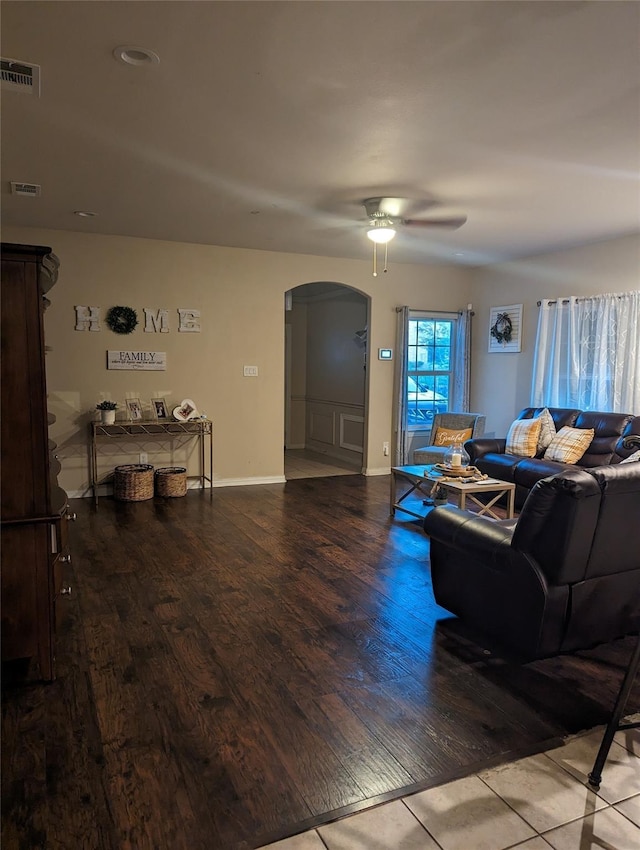 2715 Britton Ave, Dallas, TX 75216 - living room with arched walkways, a ceiling fan, wood finished floors, and baseboards