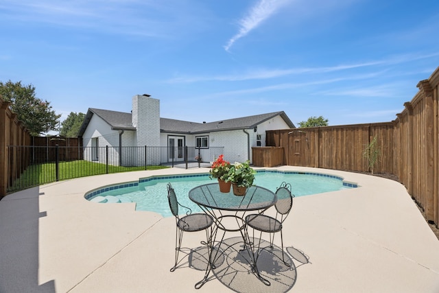 1629 Mesquite Trl, Plano, TX 75023 - view of swimming pool featuring a patio, a fenced backyard, and french doors