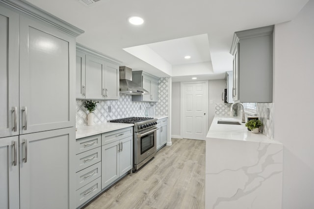 1629 Mesquite Trl, Plano, TX 75023 - kitchen featuring wall chimney exhaust hood, stainless steel appliances, gray cabinetry, a raised ceiling, and recessed lighting