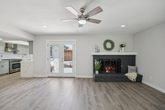 1629 Mesquite Trl, Plano, TX 75023 - unfurnished living room featuring french doors, light wood-type flooring, a fireplace, ceiling fan, and baseboards