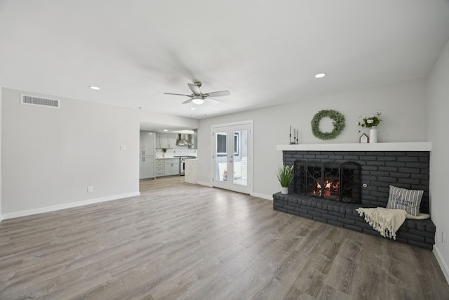 1629 Mesquite Trl, Plano, TX 75023 - living area featuring a fireplace, light wood-style flooring, a ceiling fan, baseboards, and recessed lighting