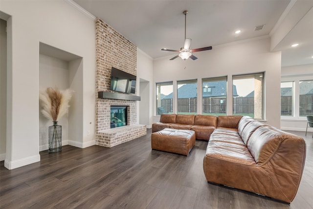 1302 Middleton Dr, Rockwall, TX 75087 - living room with wood finished floors, crown molding, ceiling fan, a brick fireplace, and baseboards