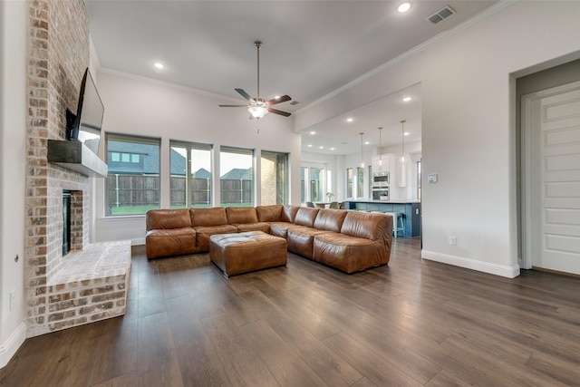 1302 Middleton Dr, Rockwall, TX 75087 - living area featuring a brick fireplace, a ceiling fan, dark wood-type flooring, baseboards, and ornamental molding