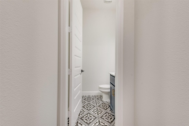 1302 Middleton Dr, Rockwall, TX 75087 - half bath featuring vanity, tile patterned flooring, and toilet