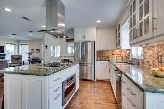 3817 Hilltop Rd, Fort Worth, TX 76109 - kitchen with stainless steel appliances, island range hood, a sink, crown molding, and light wood-type flooring