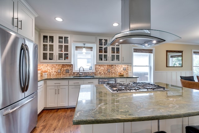3817 Hilltop Rd, Fort Worth, TX 76109 - kitchen featuring appliances with stainless steel finishes, island range hood, a sink, a kitchen island, and dark stone countertops