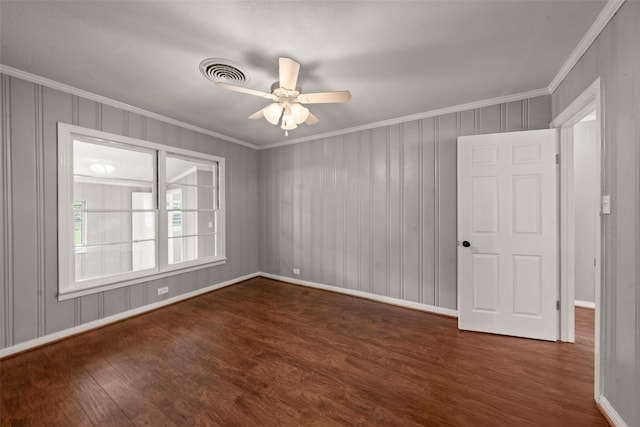1403 E Texas Ave, Mart, TX 76664 - spare room with ornamental molding, dark wood-style floors, baseboards, and ceiling fan