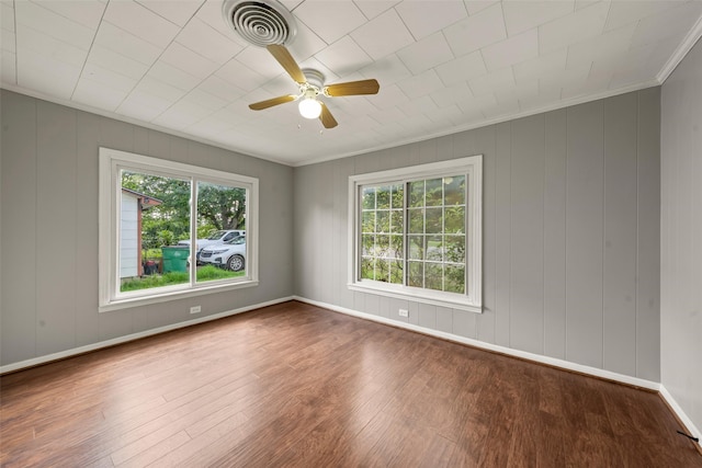 1403 E Texas Ave, Mart, TX 76664 - spare room with wood finished floors, plenty of natural light, ornamental molding, a ceiling fan, and baseboards