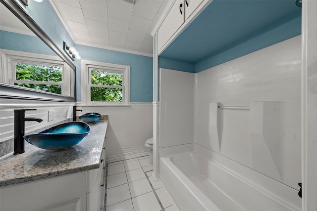 1403 E Texas Ave, Mart, TX 76664 - full bath featuring vanity, tile patterned floors, ornamental molding, a wainscoted wall, and toilet
