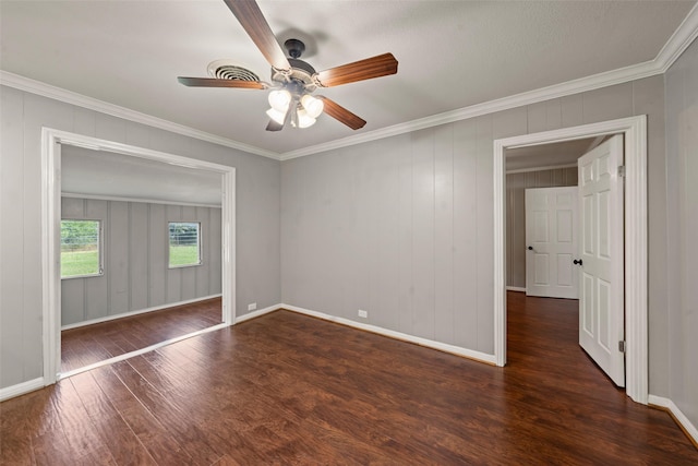 1403 E Texas Ave, Mart, TX 76664 - spare room featuring wood finished floors, a ceiling fan, ornamental molding, and baseboards