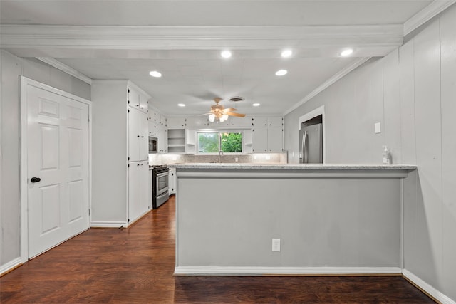 1403 E Texas Ave, Mart, TX 76664 - kitchen featuring appliances with stainless steel finishes, ceiling fan, a peninsula, crown molding, and white cabinets