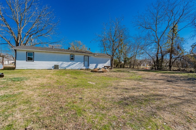 2401 Gilmer St, Caddo Mills, TX 75135 - back of property featuring a yard and central AC unit