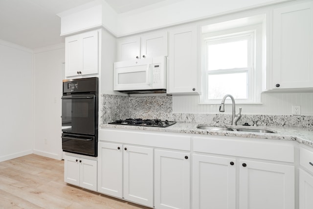 2401 Gilmer St, Caddo Mills, TX 75135 - kitchen with oven, a warming drawer, white microwave, a sink, and white cabinetry