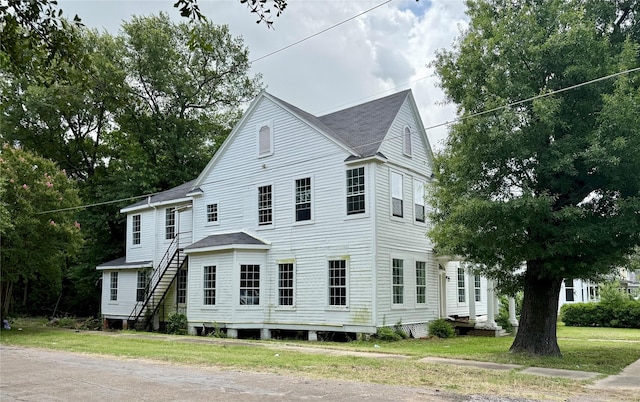 1703 Highland Ave, Shreveport, LA 71101 - view of front of property with stairway, a front lawn, and roof with shingles