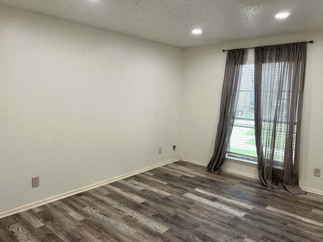 5502 Boca Raton Blvd Unit 329, Fort Worth, TX 76112 - spare room featuring dark wood-style floors, healthy amount of natural light, recessed lighting, a textured ceiling, and baseboards