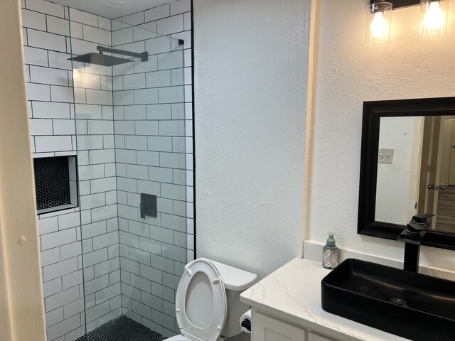 5502 Boca Raton Blvd Unit 329, Fort Worth, TX 76112 - full bathroom with toilet, vanity, tiled shower, and a textured wall