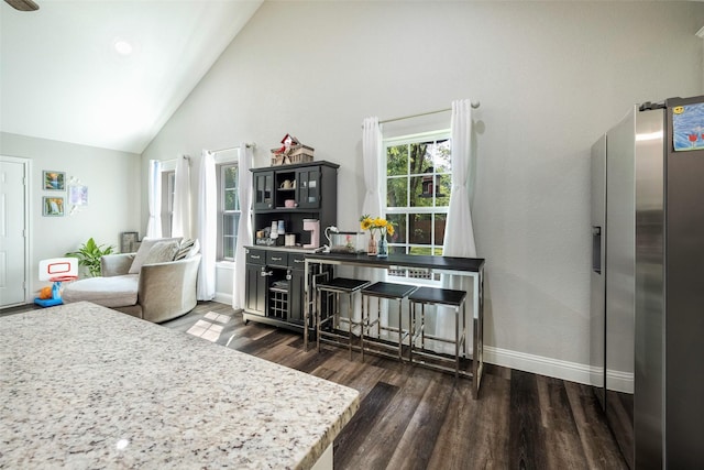 1004 San Jacinto St, Terrell, TX 75160 - kitchen featuring stainless steel fridge with ice dispenser, wood finished floors, baseboards, and high vaulted ceiling