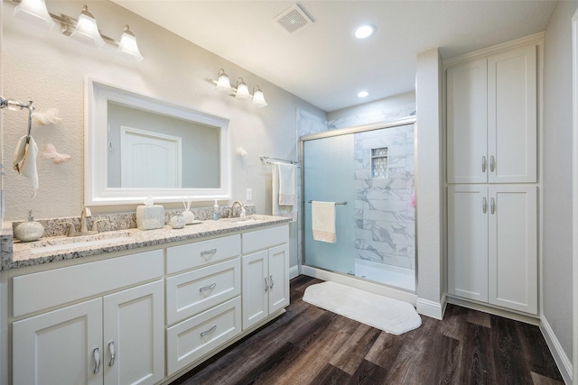 1004 San Jacinto St, Terrell, TX 75160 - bathroom featuring a shower stall, double vanity, wood finished floors, and recessed lighting