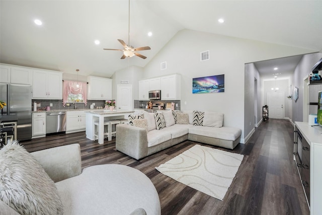 1004 San Jacinto St, Terrell, TX 75160 - living area with a ceiling fan, dark wood-style floors, recessed lighting, high vaulted ceiling, and baseboards