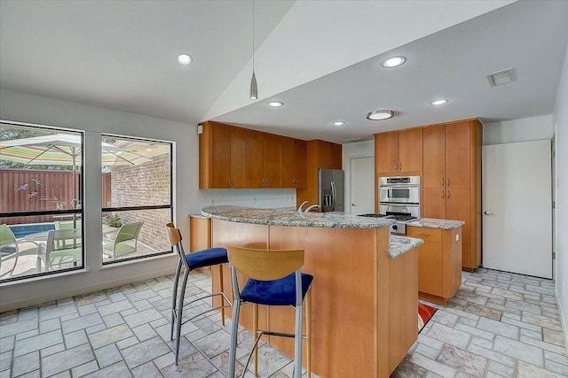 3108 Landershire Ln, Plano, TX 75023 - kitchen with stainless steel fridge with ice dispenser, brown cabinets, recessed lighting, a peninsula, and a kitchen breakfast bar