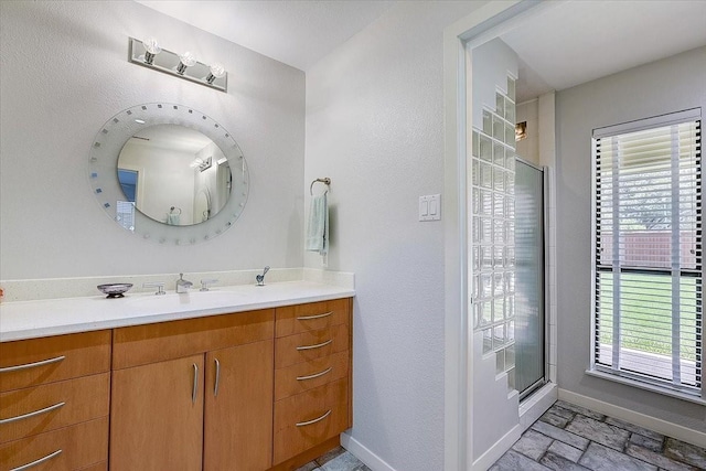 3108 Landershire Ln, Plano, TX 75023 - bathroom with baseboards, vanity, healthy amount of natural light, and an enclosed shower