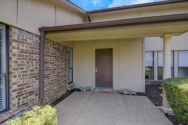 3108 Landershire Ln, Plano, TX 75023 - doorway to property with brick siding, board and batten siding, and a patio