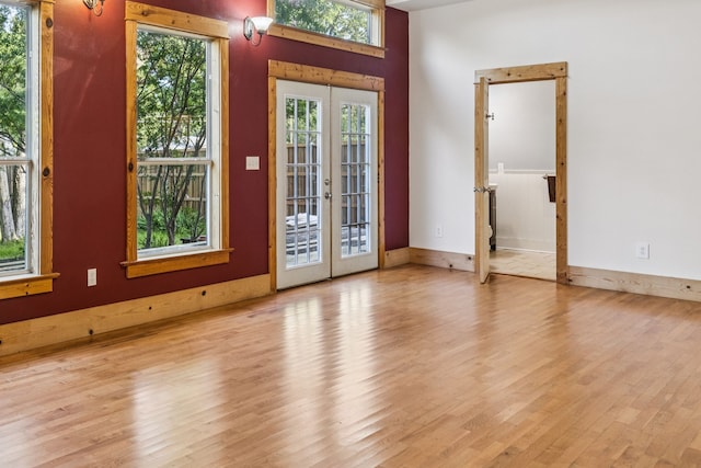 5620 Victor St, Dallas, TX 75214 - empty room featuring french doors, wood finished floors, and baseboards