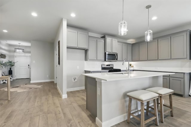 1708 Lapetus, Haslet, TX 76052 - kitchen featuring stainless steel microwave, gray cabinetry, gas range oven, baseboards, and recessed lighting