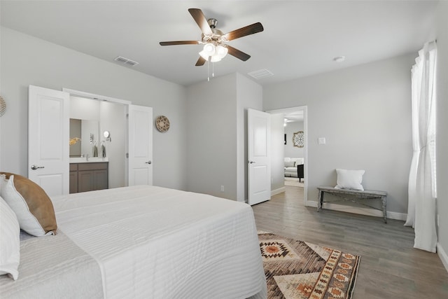 1708 Lapetus, Haslet, TX 76052 - bedroom featuring wood finished floors, baseboards, ensuite bath, and ceiling fan