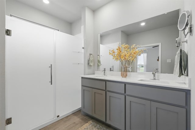 1708 Lapetus, Haslet, TX 76052 - bathroom featuring wood finished floors, double vanity, recessed lighting, and a shower with shower door