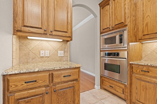 401 Shumard Oak Trl, Keller, TX 76248 - kitchen with stainless steel appliances, light stone counters, crown molding, and backsplash