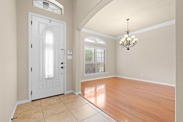 401 Shumard Oak Trl, Keller, TX 76248 - foyer entrance with a chandelier, arched walkways, light tile patterned flooring, and ornamental molding