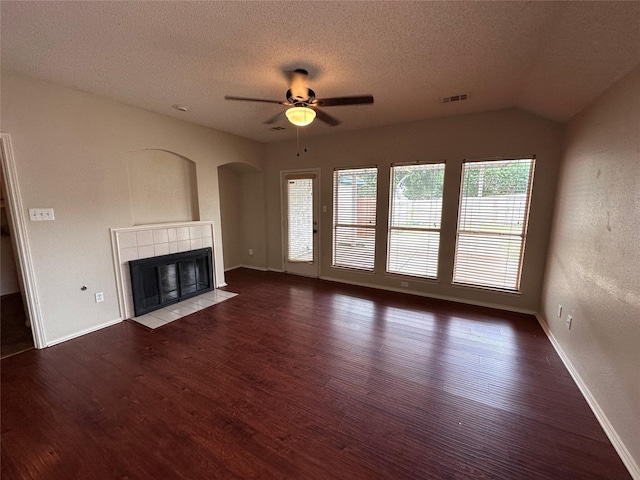 4102 Baccarat Dr, Garland, TX 75043 - unfurnished living room with wood finished floors, a ceiling fan, a fireplace, a textured ceiling, and baseboards