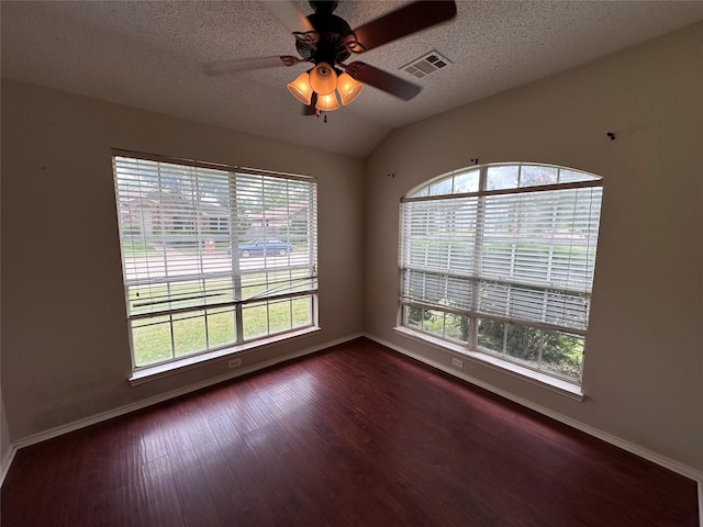 4102 Baccarat Dr, Garland, TX 75043 - empty room featuring dark wood-style floors, baseboards, ceiling fan, a textured ceiling, and vaulted ceiling
