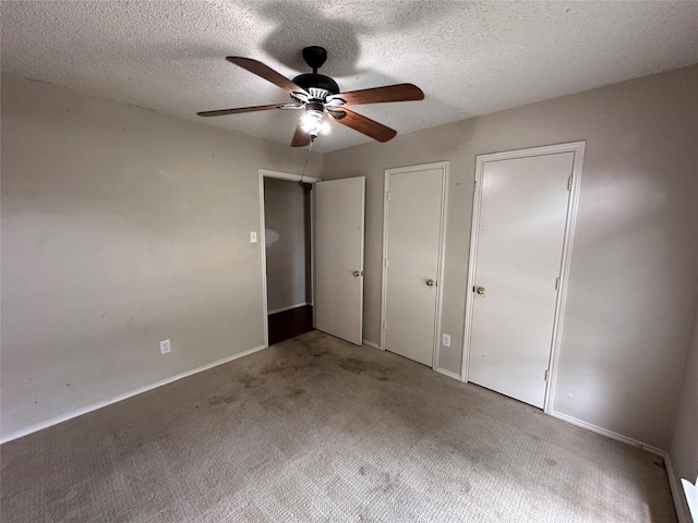 4102 Baccarat Dr, Garland, TX 75043 - unfurnished bedroom with multiple closets, carpet floors, a textured ceiling, baseboards, and ceiling fan