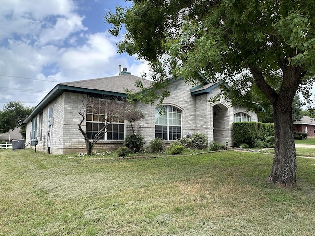 4102 Baccarat Dr, Garland, TX 75043 - view of front of home with brick siding, a front lawn, and cooling unit