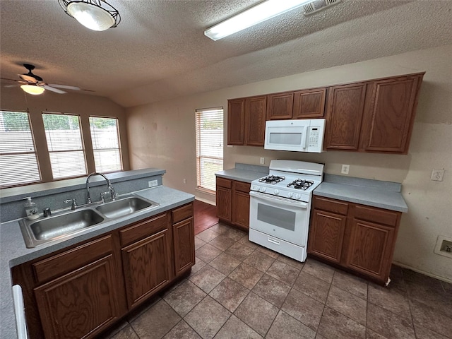 4102 Baccarat Dr, Garland, TX 75043 - kitchen featuring white appliances, a sink, ceiling fan, a textured ceiling, and vaulted ceiling