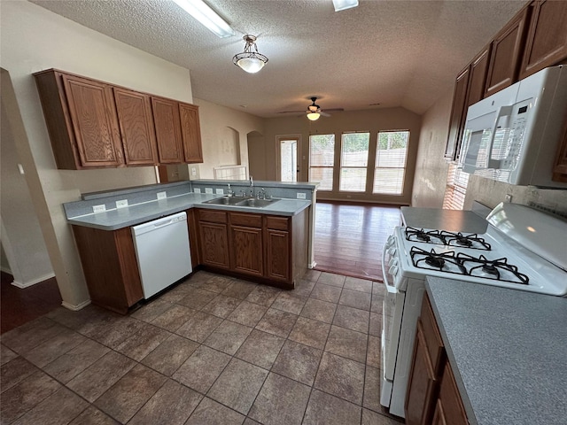 4102 Baccarat Dr, Garland, TX 75043 - kitchen with white appliances, a sink, a ceiling fan, a peninsula, and a textured ceiling