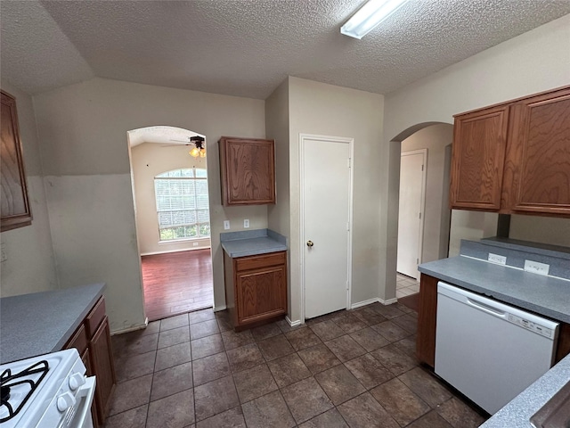 4102 Baccarat Dr, Garland, TX 75043 - kitchen featuring white appliances, arched walkways, ceiling fan, a textured ceiling, and light countertops
