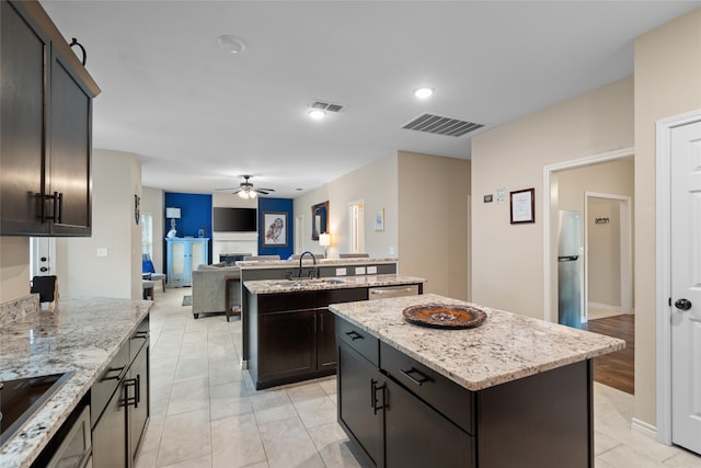 8208 Burleigh St, Frisco, TX 75035 - kitchen featuring a center island, a ceiling fan, appliances with stainless steel finishes, a sink, and open floor plan