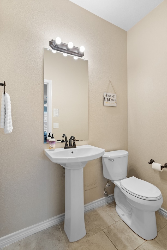 8208 Burleigh St, Frisco, TX 75035 - bathroom featuring toilet, tile patterned flooring, a sink, and baseboards
