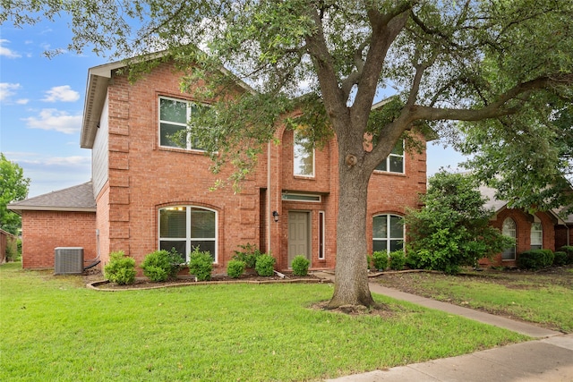 8208 Burleigh St, Frisco, TX 75035 - traditional-style house with central AC, brick siding, a front yard, and roof with shingles